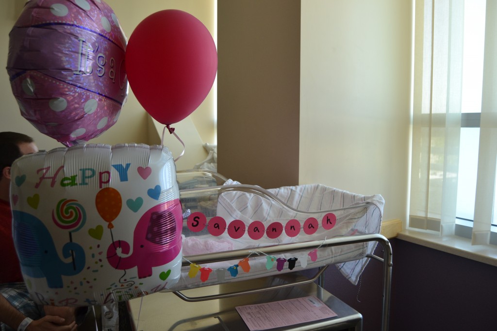 Auntie Sissy brought balloons and made an adorable banner for her bassinet. =)